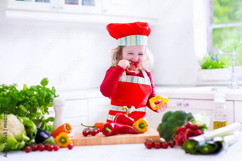 Little girl in chef hat preparing lunch Little girl in chef hat preparing lunch