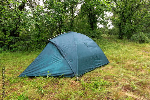 tourist tent in wet forest