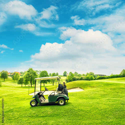 Golf course lanscape with a cart over blue sky background Retro