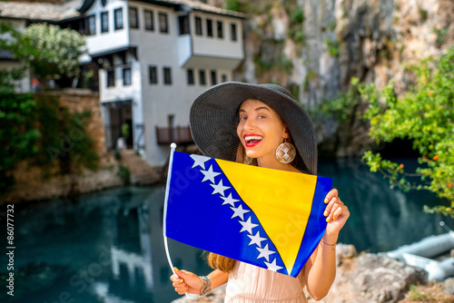 Quadro su tela Woman with Bosnian flag in Blagaj village