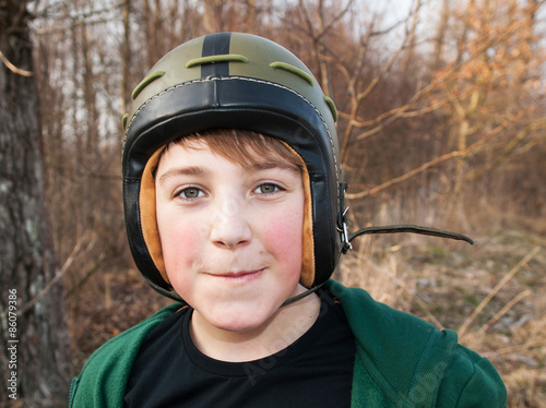 Young boy in army helmet © sci