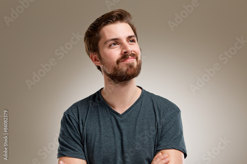 Portrait of young man with beard, think about