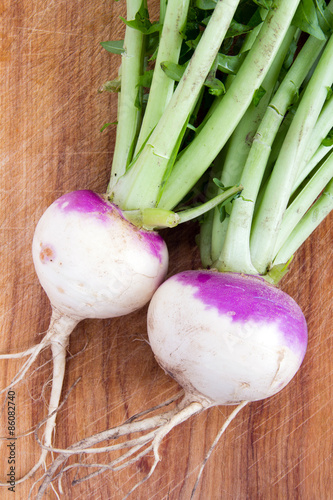 two organic purple top turnip on table