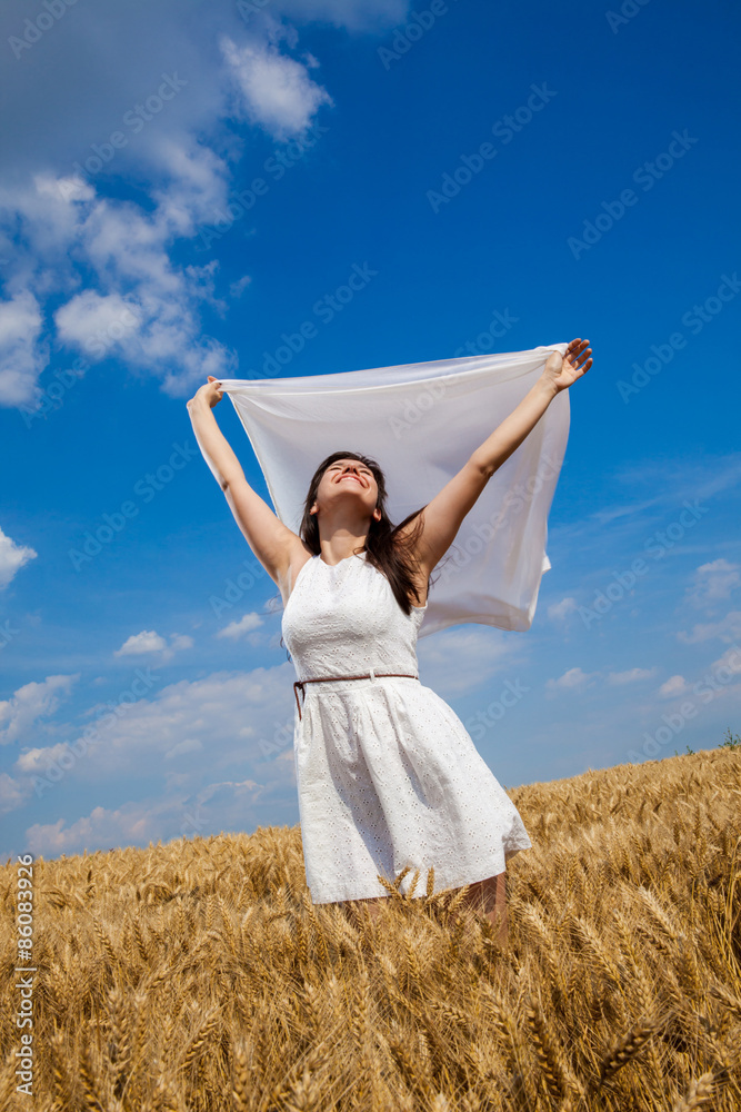 Happy young woman enjoying life in golden wheat field Happy young woman enjoying life in golden wheat field