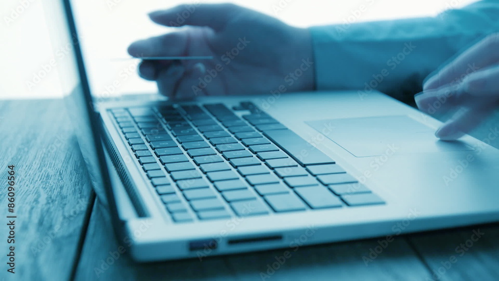 woman using computer for on line purchase with credit card.
woman using computer for on line purchase with credit card.