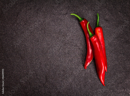 chili pepper on black stone background