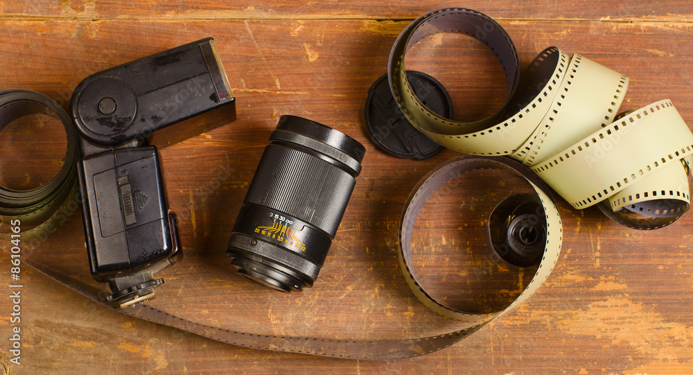 old film for the camera, a lens and flashlight old film for the camera, a lens and flashlight