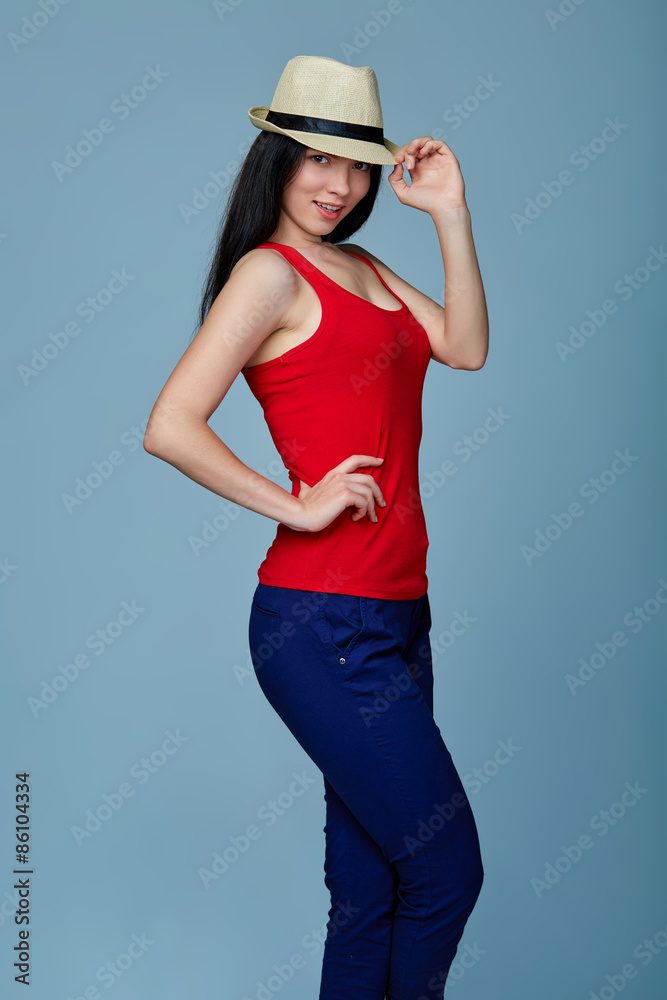 Natural smiling teen girl posing in blank red tshirt and straw h