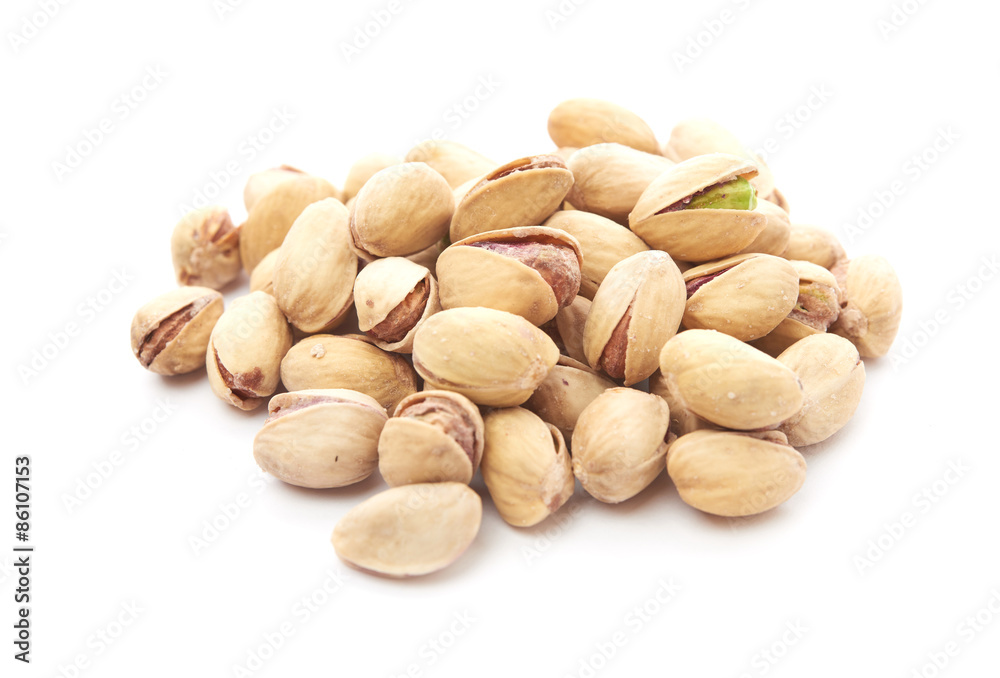 Heap of pistachios nuts isolated on the white Heap of pistachios nuts isolated on the white