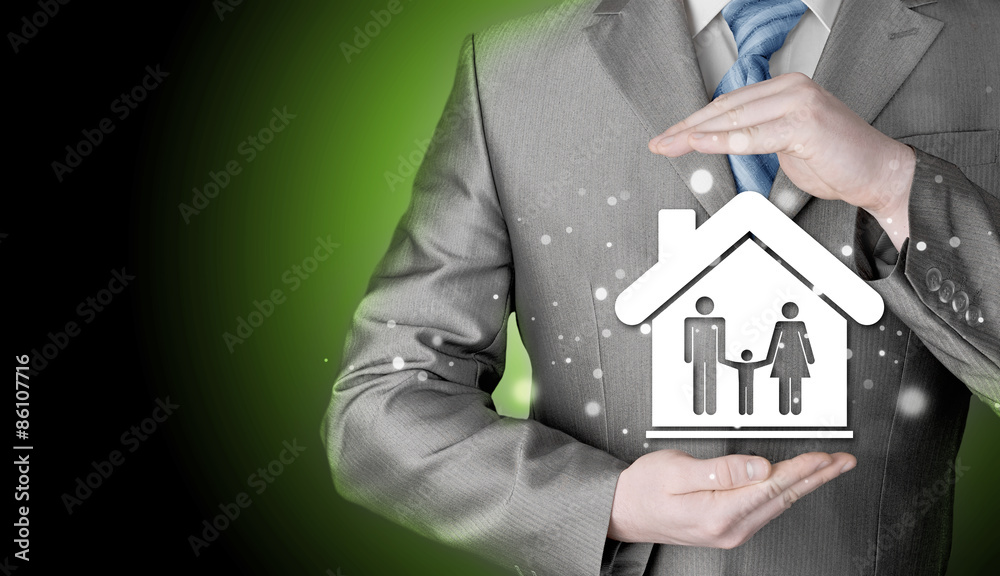 businessman protecting family in home with hands businessman protecting family in home with hands