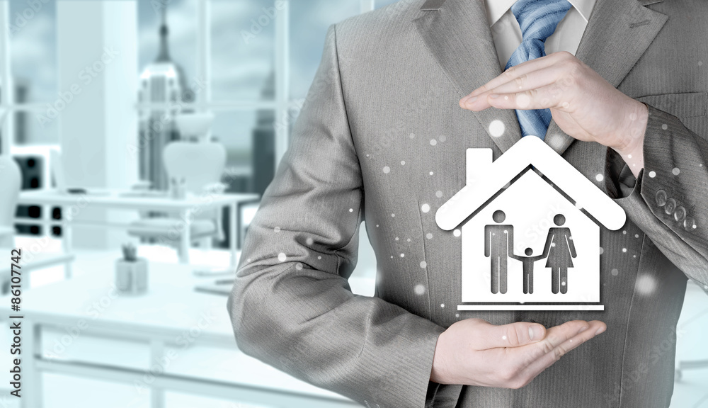 businessman protecting family in home with hands businessman protecting family in home with hands