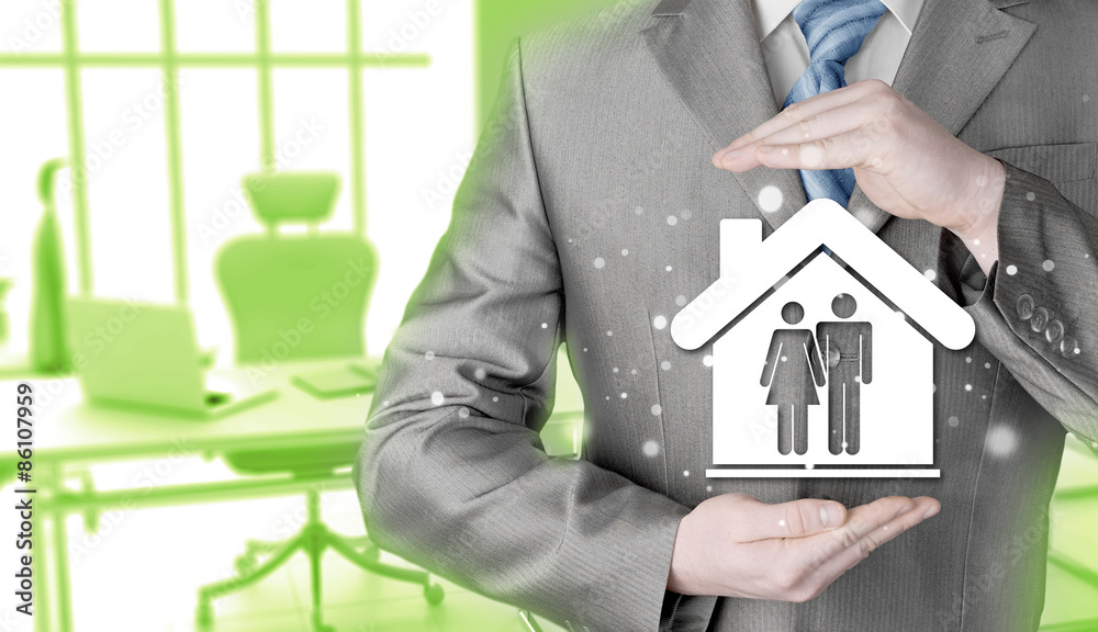 businessman protecting family in home with hands businessman protecting family in home with hands