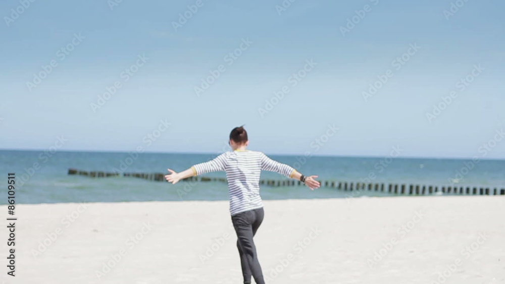 Happy woman running on the beach, slow motion Happy woman running on the beach, slow motion