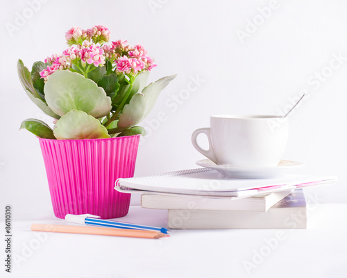 Workplace with flower books and a coffee cup