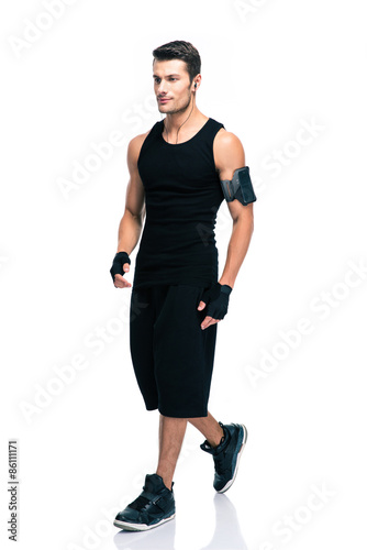Full length portrait of a fitness man walking