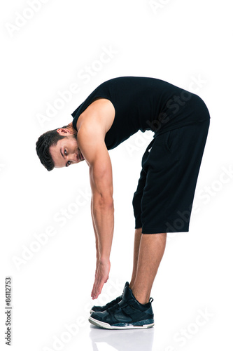 Full length portrait of a fitness man stretching