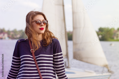 Portrait of a beautiful young woman floating on a yacht.