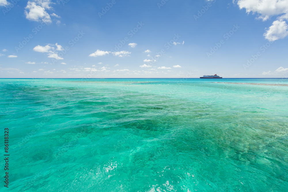 Image of a cruise ship sailing along the coast line