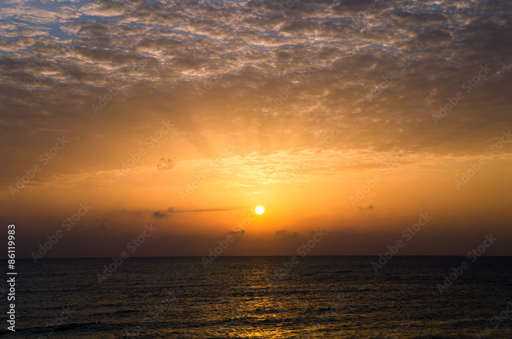 Dramatic sunset with dark clouds in the sea Dramatic sunset with dark clouds in the sea