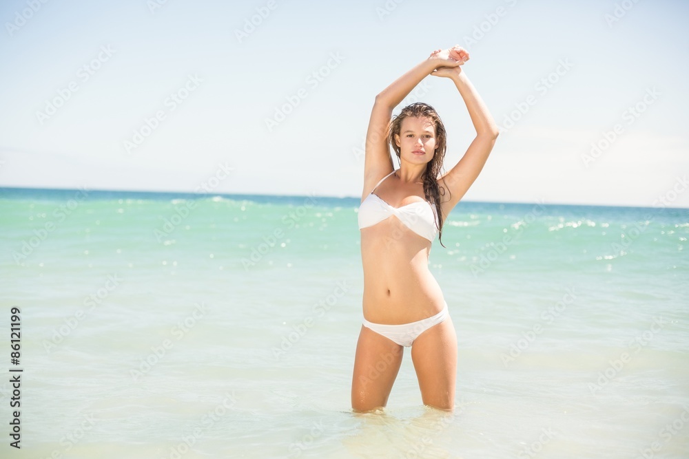 Pretty blonde looking at camera into the sea