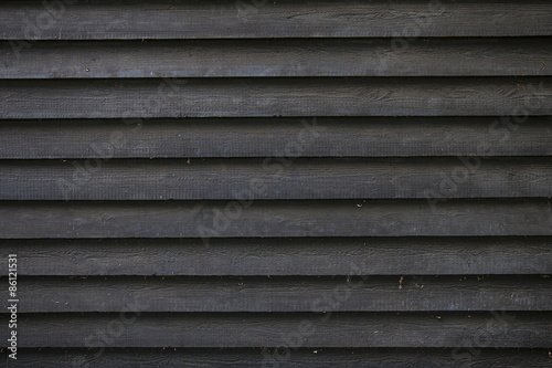 part of black wooden fence or part of barn