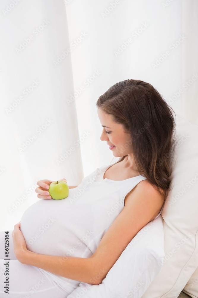 Happy pregnancy with an apple on his belly Happy pregnancy with an apple on his belly