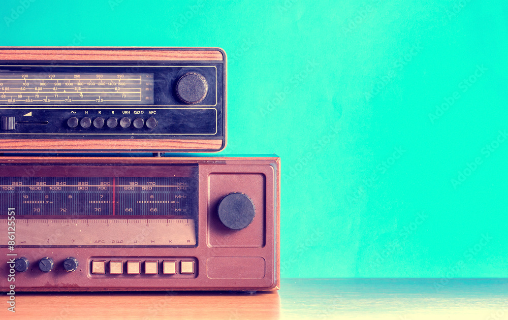Fototapeta premium Old radios on blue background, filtered photo