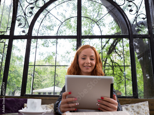 Pretty girl posing with a tablet