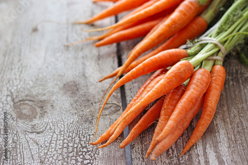 Fresh organic carrots on wooden background, selective focus