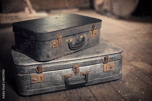 Photo of old vintage suitcases in a dusty attic, travel and nostalgia concept