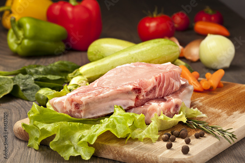 Slices of raw meat with vegetables and spices for cooking and ba