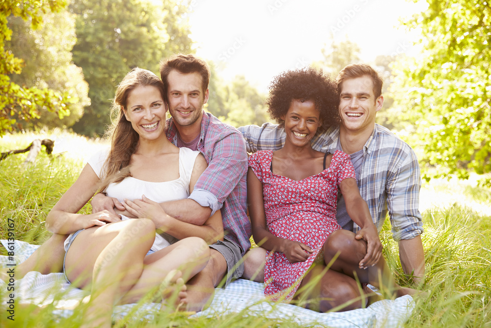 Fototapeta premium Two couples relaxing together in the countryside