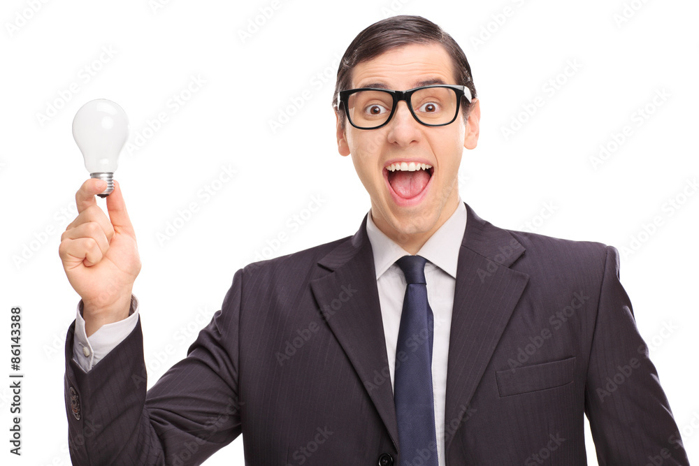 Excited businessman in a black suit holding a light bulb Excited businessman in a black suit holding a light bulb