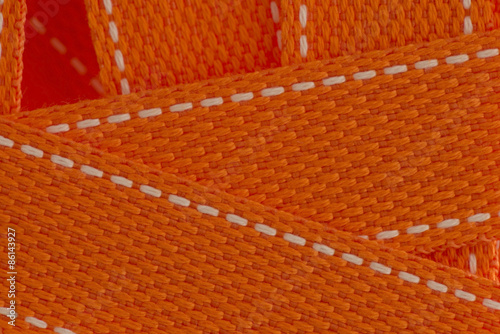 Obraz na plátně Orange strap belt macro closeup as background.