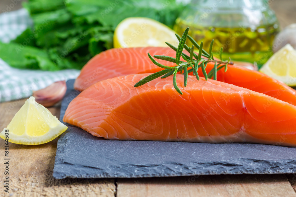 Fresh raw salmon fillet with rosemary and lemon Fresh raw salmon fillet with rosemary and lemon
