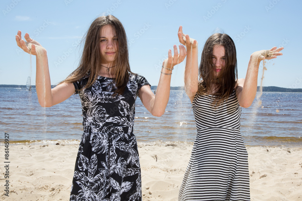 Twins, sisters have fun togetaher at the beach Twins, sisters have fun togetaher at the beach