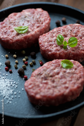 Close-up of raw cutlets made of ground beef meat, studio shot