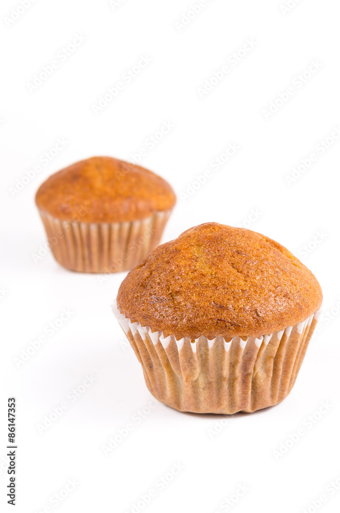 Two brown banana muffin in paper cupcake holder isolated on whit Two brown banana muffin in paper cupcake holder isolated on whit