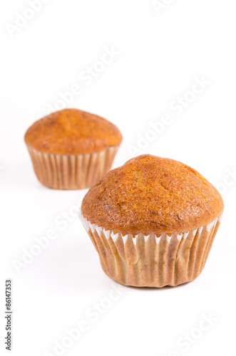 Two brown banana muffin in paper cupcake holder isolated on whit