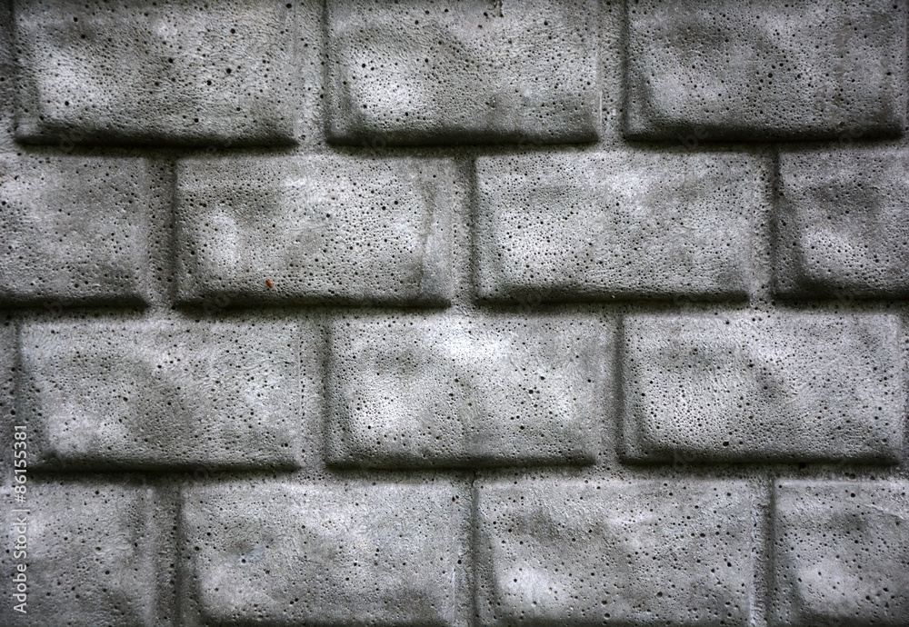 Fototapeta premium Grey brick wall as a background. Closeup view