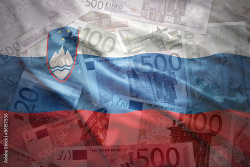 Photos colorful waving slovenian flag on a euro money background