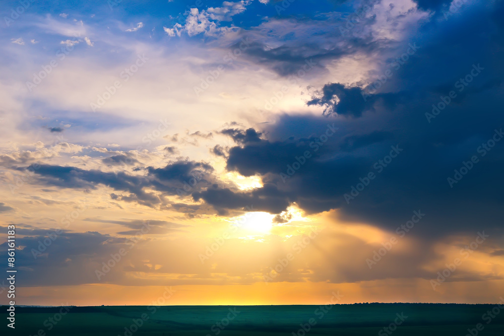 Obraz premium bright sunset in cloudy sky