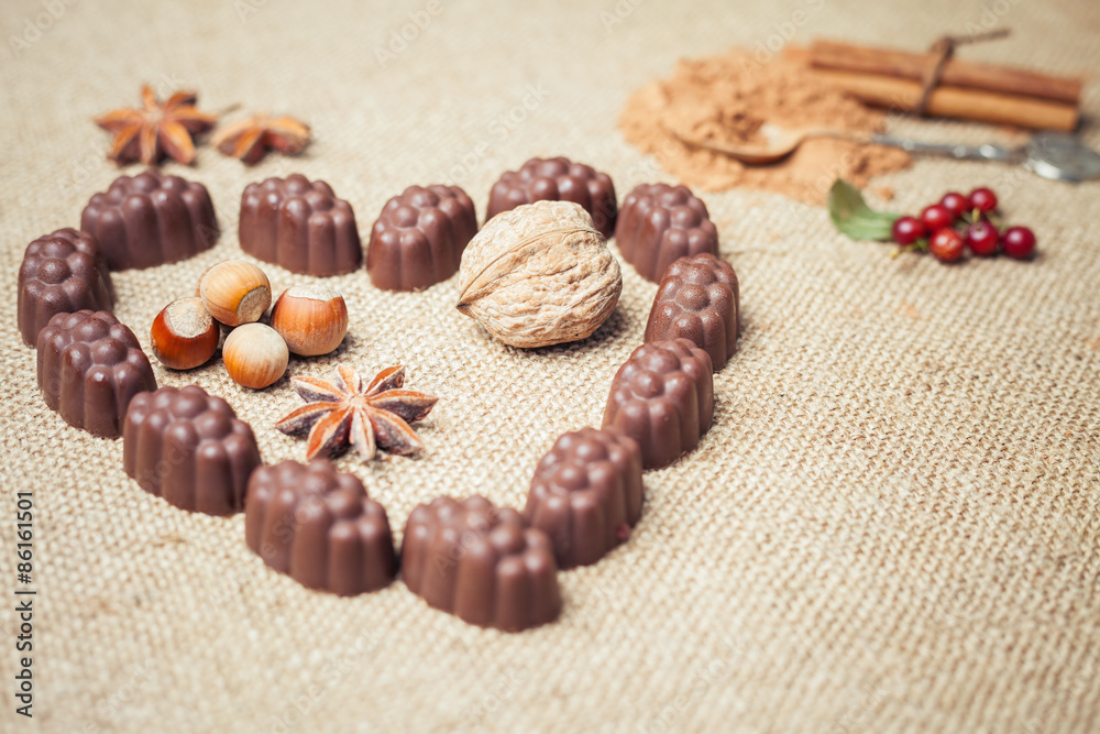 Chocolate candies with liquor in form of heart on background Chocolate candies with liquor in form of heart on background
