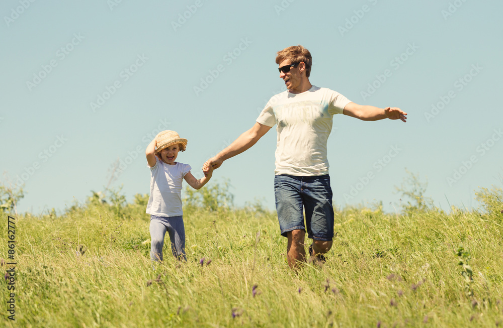 Father with the daughter running on the field Father with the daughter running on the field
