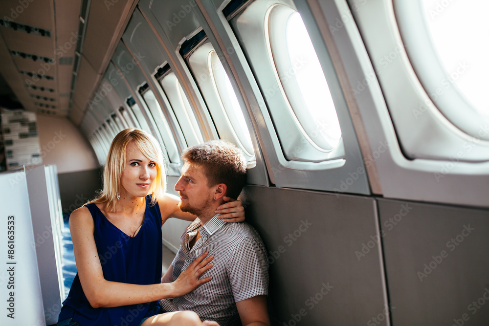 Fototapeta premium Young couple on board the aircraft