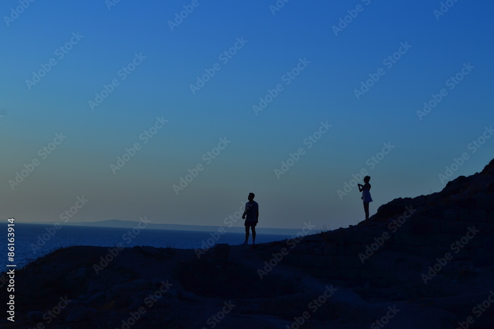 Couple taking photos each other at sunset Couple taking photos each other at sunset