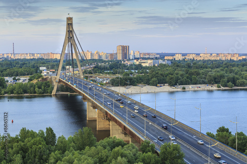 Bridge over Dnipro River in Kyiv city at sunset