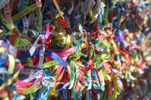 Colorful Brazilian wish ribbons tied to a fence at the Bonfim Church Salvador Bahia Brazil [translation: Memory of Bonfim Church]