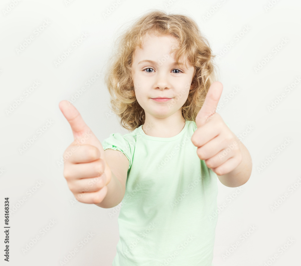 Little girl with thumbs up on white background Little girl with thumbs up on white background