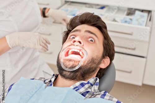 young man and woman in a dental examination at dentist